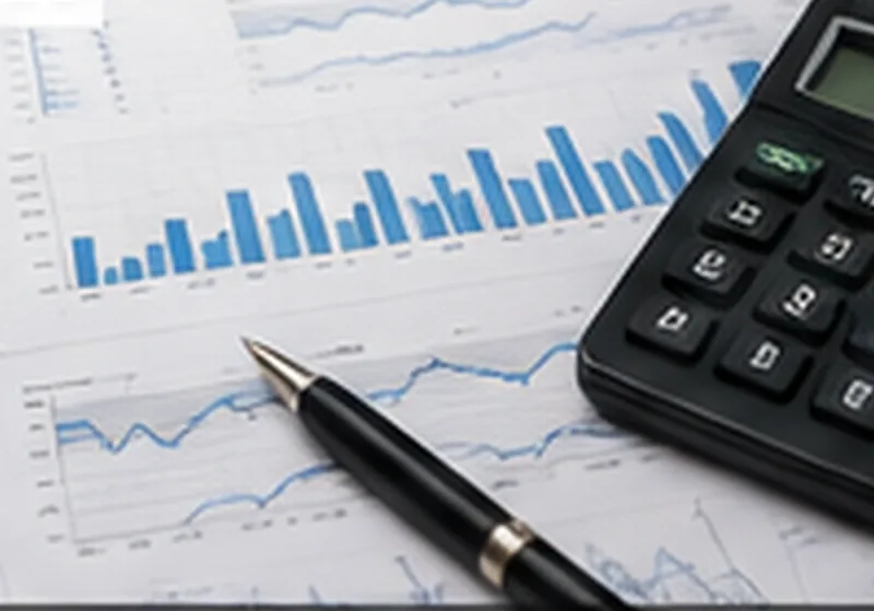 Financial charts, calculator and pen representing investment analysis