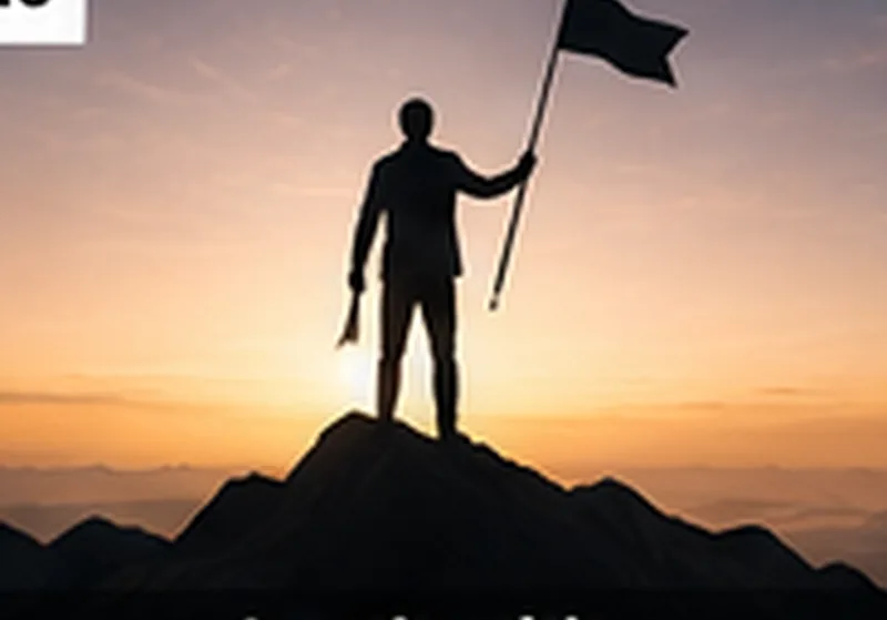 Leader standing on a mountain at sunrise holding a flag